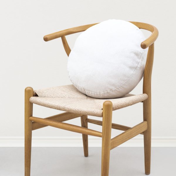 Linen cushion cover in white on a chair